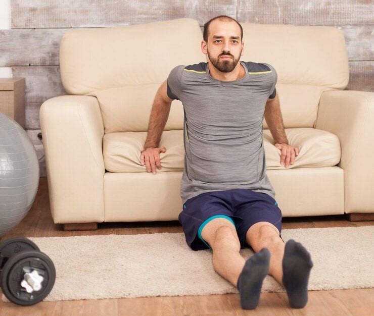 fit-man-using-sofa-train-triceps-coronavirus-lockdown_482257-20823.2