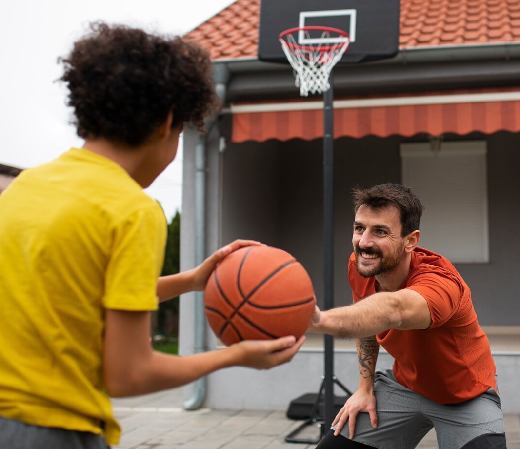 father-son-playing-basketball-together-backyard_23-2150067861