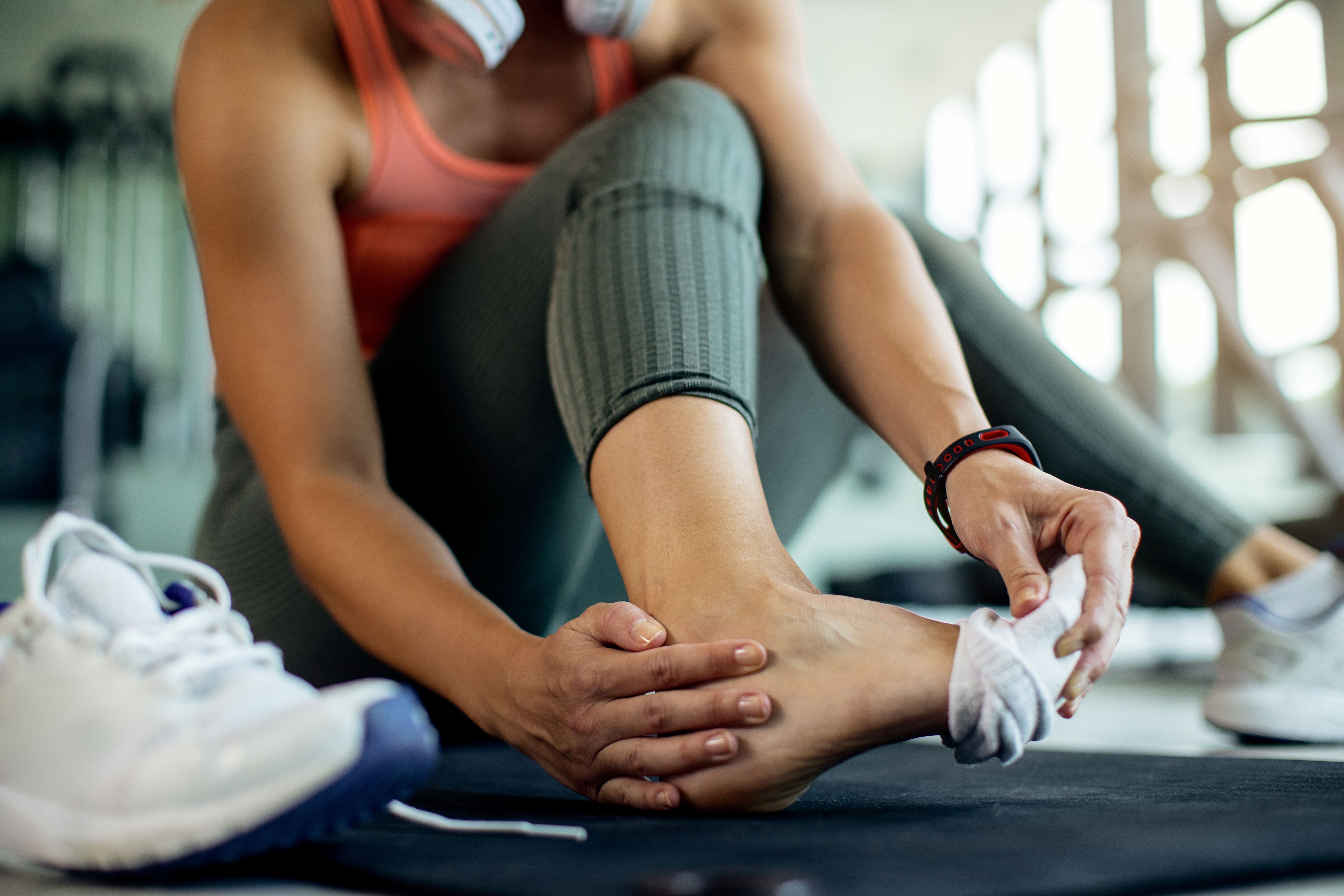 closeup-athletic-woman-injured-her-foot-workout-gym_compressed